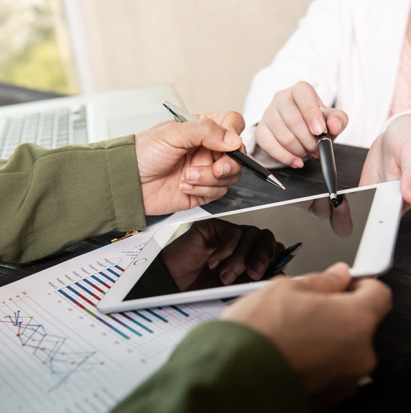 Business professional reviewing financial charts and analytics for market valuation