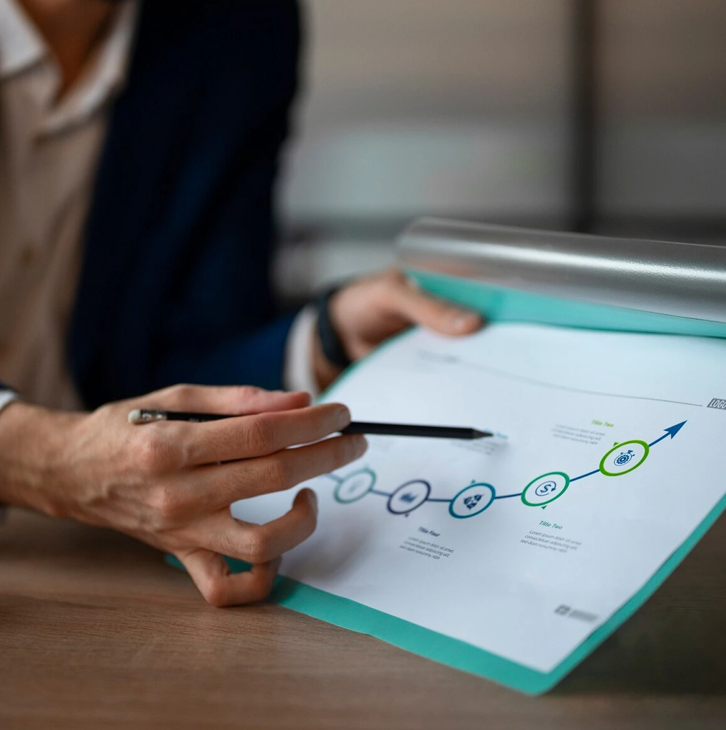 Business professional analyzing upward-trending financial graph during negotiation phase