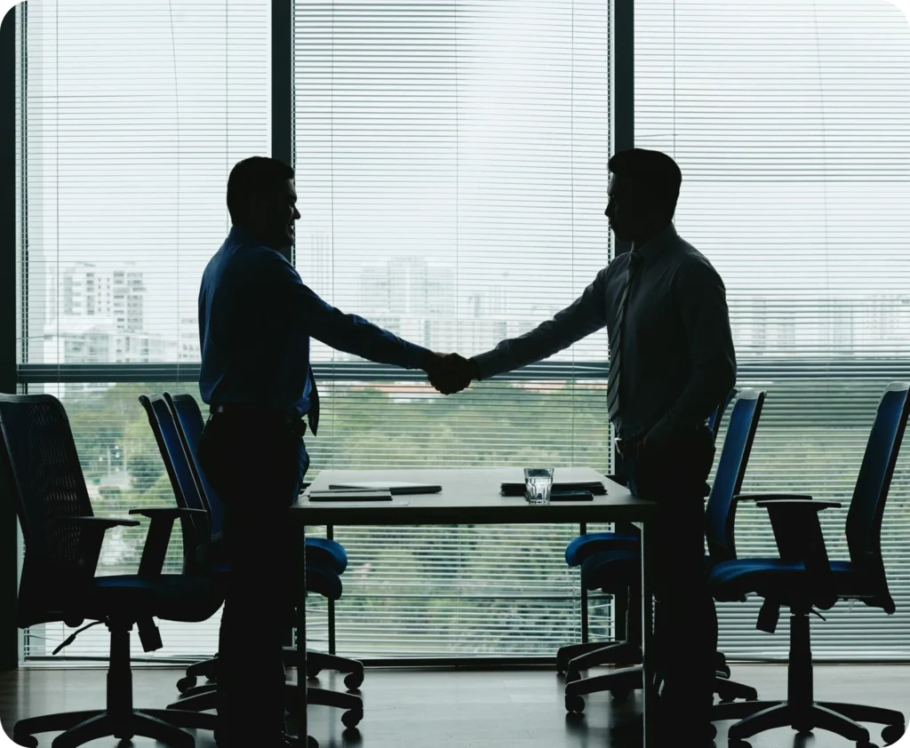 Business professionals negotiating deal in corporate boardroom